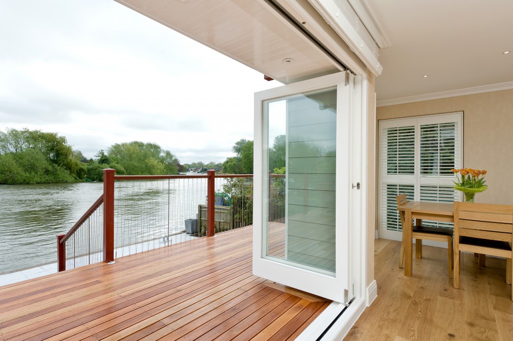 painted bi fold doors opening onto decking